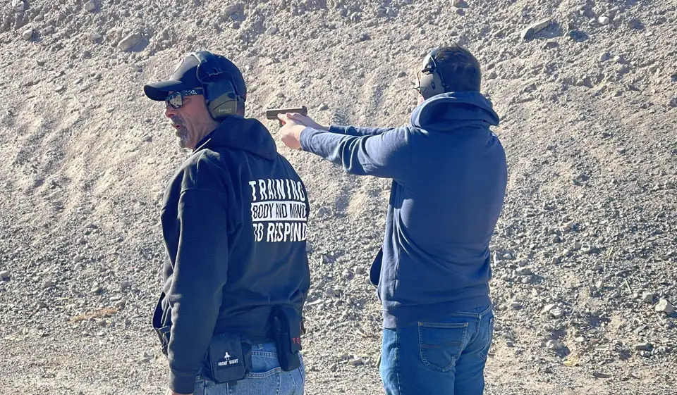 Bob Sturner coaching a student on the range